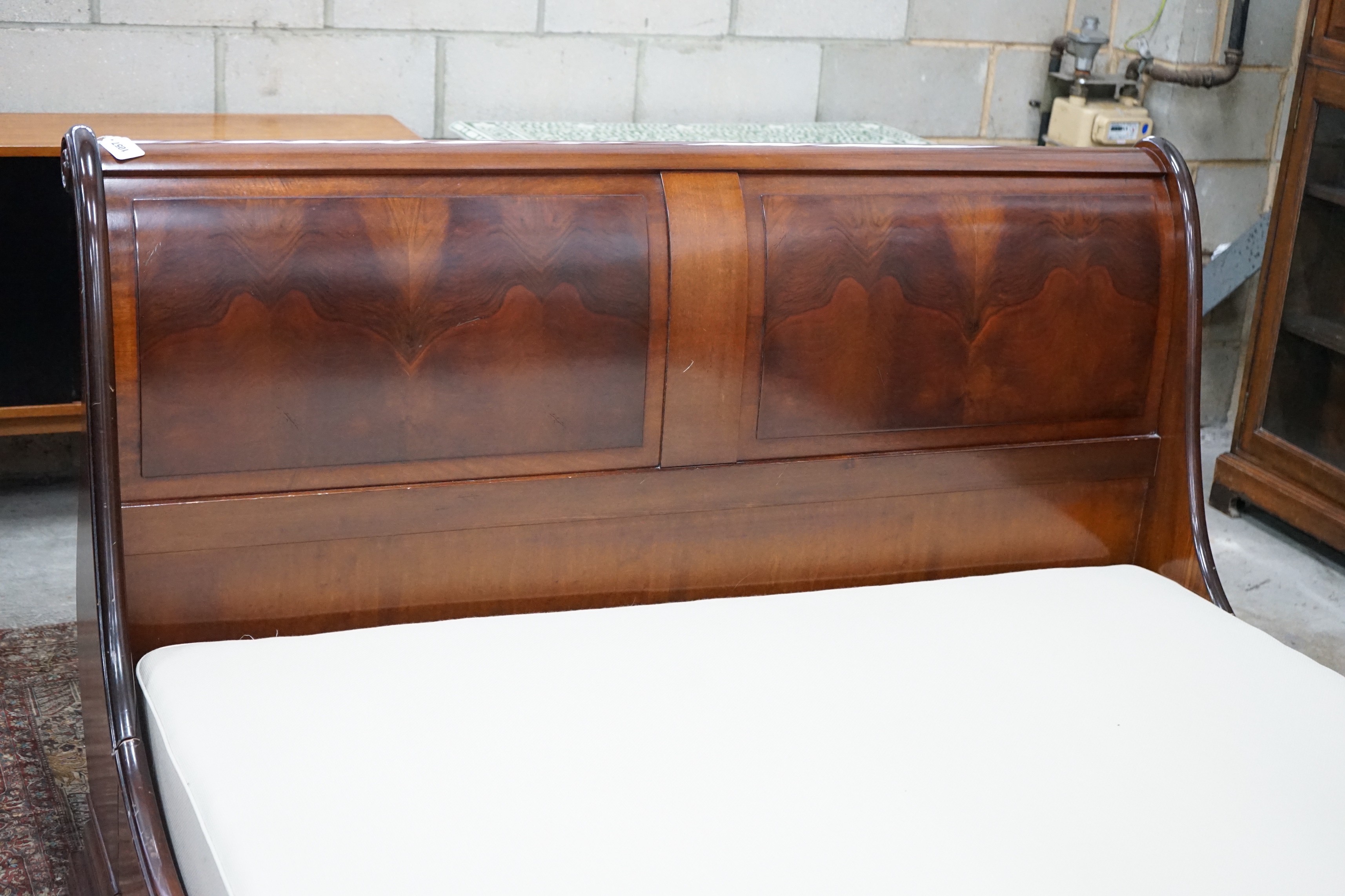 An 'And So To Bed' mahogany kingsize sleigh bed with Prestige two section divan base, width 161cms, length 224cms, height 100cms
